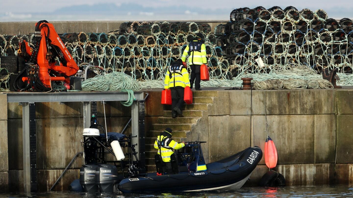 Gardaí and members of the Irish Coast Guard alongside the Quay at Blacksod, Co Mayo. Photograph: Chris Radburn/PA
