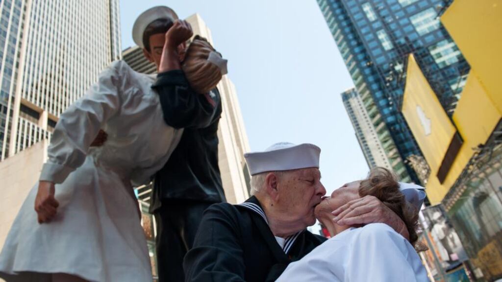 Second World War veterans Ray and Ellie Williams recreate the iconic Alfred Eisenstaedt photograph in Times Square in New York City in front of a sculpture modelled on the image. Photograph: Bryan Thomas/Getty Images