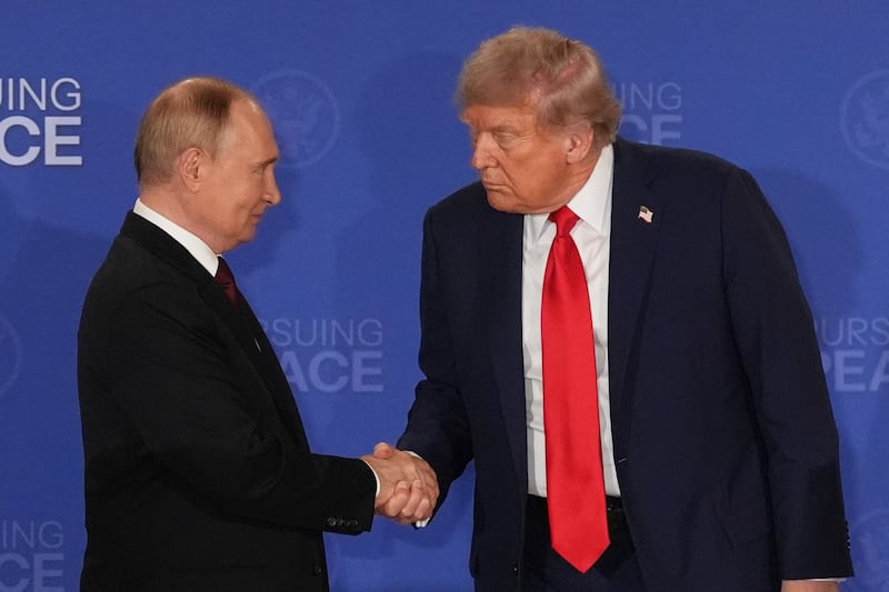 President Donald Trump, right, shakes the hand of Russia’s president Vladimir Putin during a joint press conference in Alaska in August. Photograph: Jae C Hong/AP