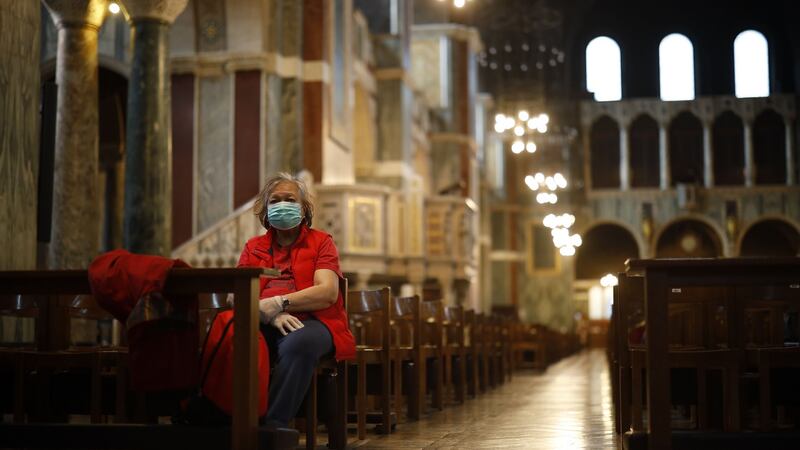 A single worshipper wearing a surgical mask sits on a pew in Westminster Cathedral in central London on March 17th. Photograph: Tolga Akmen/AFP/Getty Images