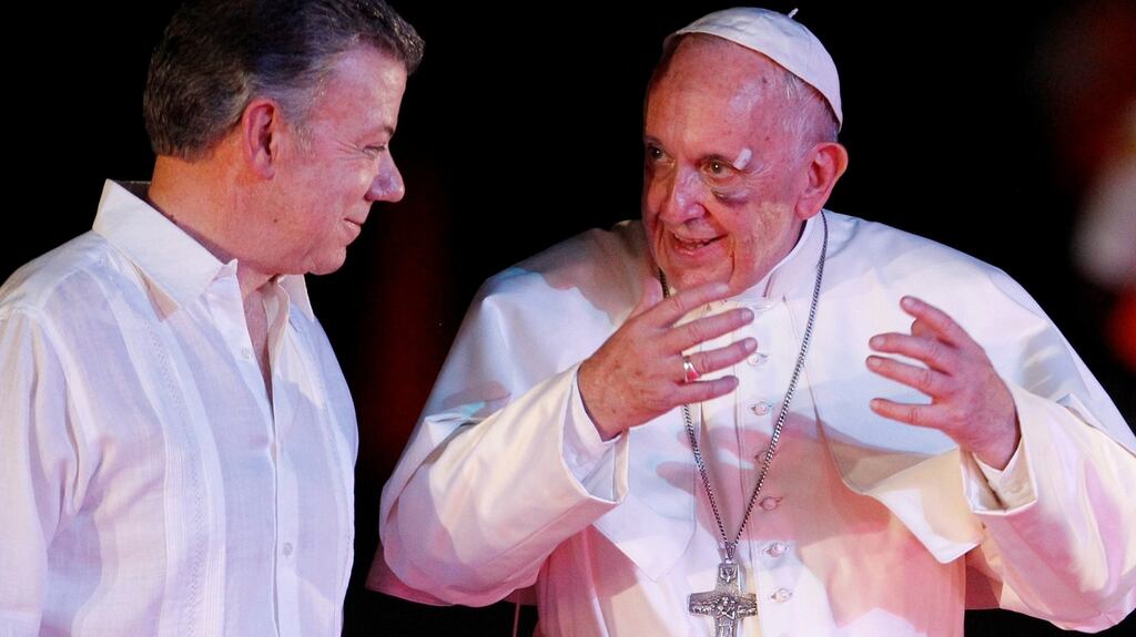 Colombia’s President Juan Manuel Santos and Pope Francis talk at the airport in Cartagena, Colombia. Photograph: Federico Rios/Reuters