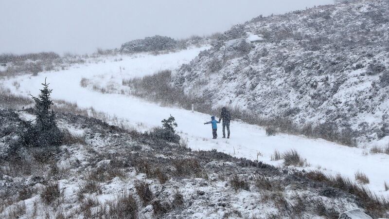 People walking in the snow in the Wicklow Gap, Co Wicklow on Sunday. A nationwide weather warning for snow and ice is in place until Monday morning. Photograph: PA