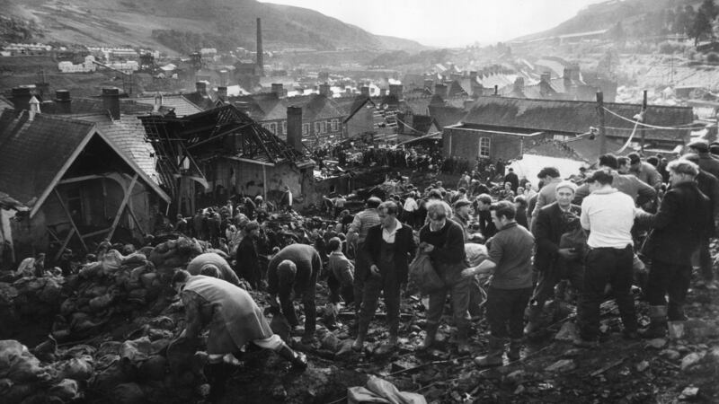 Helpers filling sandbags on the tip above the shattered Pantglas Junior School to divert a spring and avert the risk of further landslides at Aberfan, South Wales. Photograph: Fox Photos/Getty Images