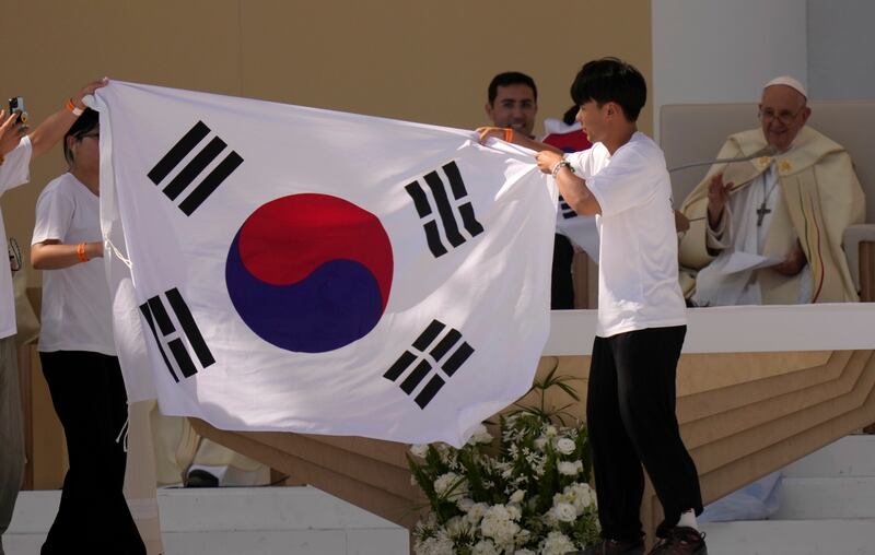 Young pilgrims from South Korea display their national flag after Pope Francis announced that the next World Youth Day will take place in Seoul in 2027. Photograph: Francisco Seco/AP