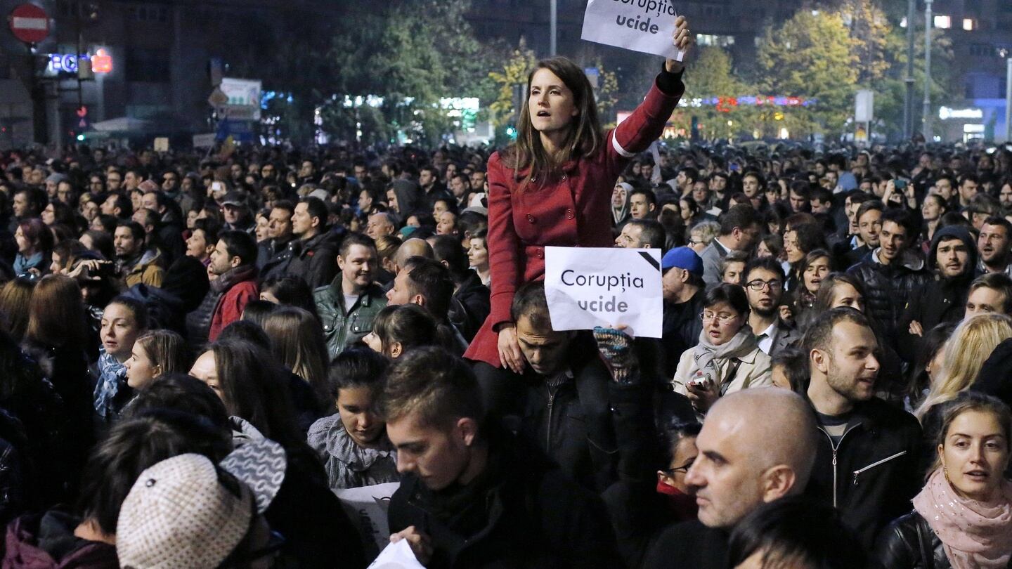 A Romanian woman shouts anti-government slogans during the rally. Photograph: EPA
