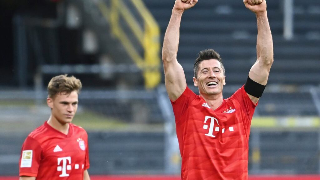 Match-winner Joshua Kimmich looks on as Robert Lewandowski celebrates Bayern’s win over Dortmund. Photograph: Federico Gambarini/AP