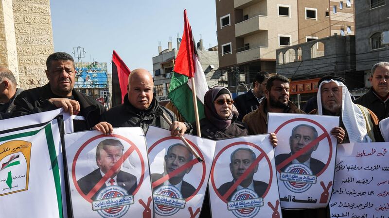 Palestinian demonstrators chant slogans while holding portraits of US president Donald Trump and Israeli prime minister Binyamin Netanyahu,in Rafah in the southern Gaza strip on Tuesday. Photograph: Said Khatib/AFP via Getty Images