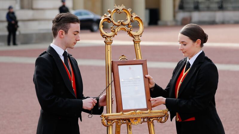 Staff set up an official notice at the gates of Buckingham Palace announcing the birth of the royal baby. Photograph: Tolga Akmen/AFP/Getty Images