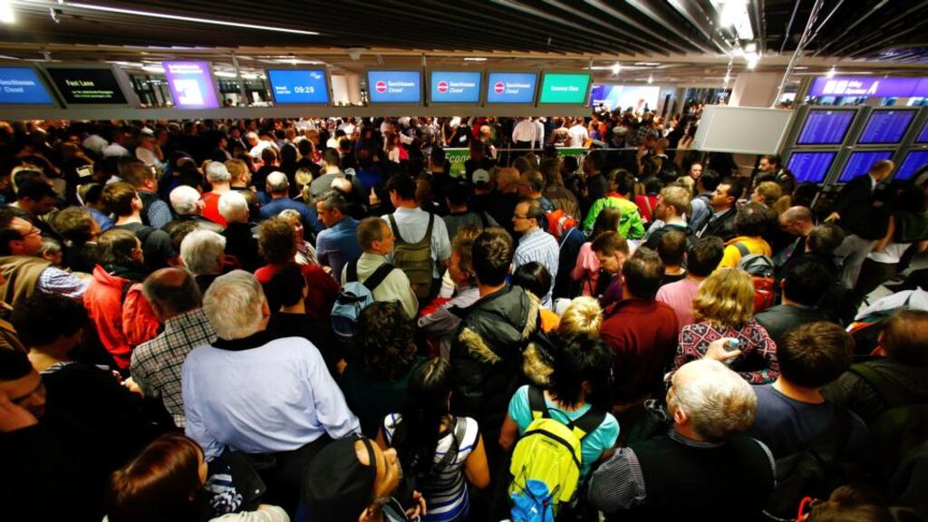 Hundreds of flight passengers wait past closed security gates during a strike in Frankfurt airport yesterday. Photograph: Reuters/Ralph Orlowski
