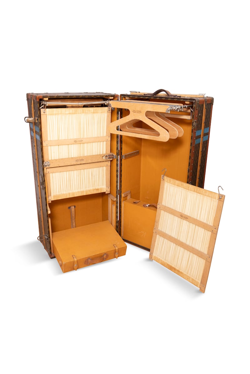 The larger trunk has hanging compartments