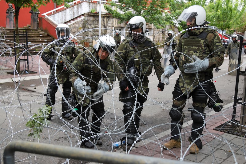 KFOR soldiers place a barbed wire in front of the city hall in the town of Zvecan. Photograph: Bojan Slavkovic/AP