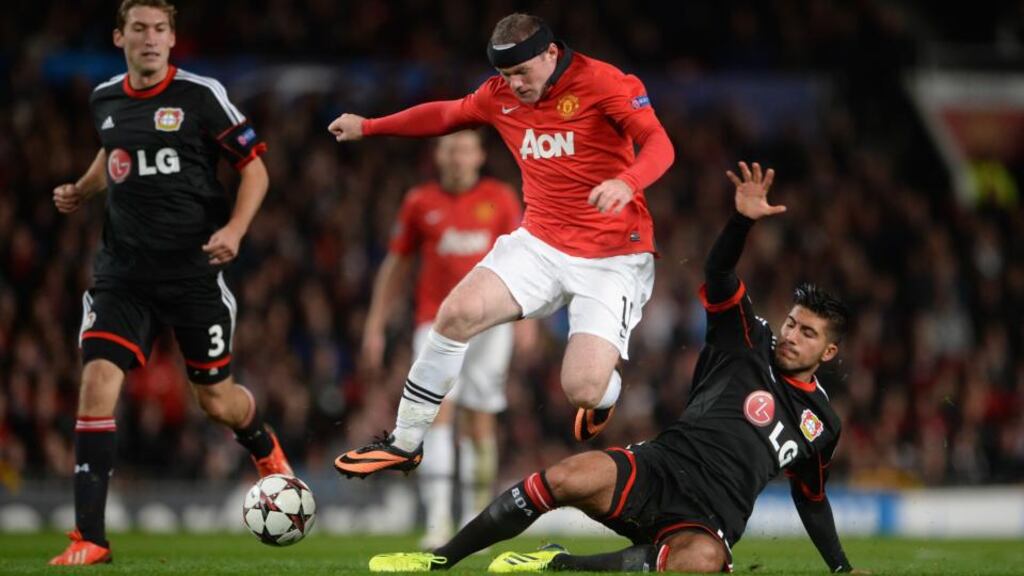 Emre Can of Bayer Leverkusen tackles Man Utd’s Wayne Rooney. Photograph: Michael Regan/Getty Images