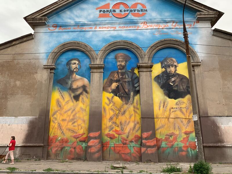 A street mural in Zaporizhzhia equates a Cossack warrior with an early 20th century Ukrainian general and a present-day soldier fighting Russia. Photograph: Lara Marlowe
