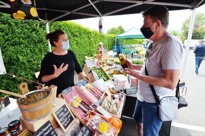 Jenny Campbell Vera foods selling to customer Tom Dyllon Killeen from Rathmichael at the W outdoor farmers Market at Whelans Wines in Loughlinstown, Dublin. Photograph: Alan Betson
