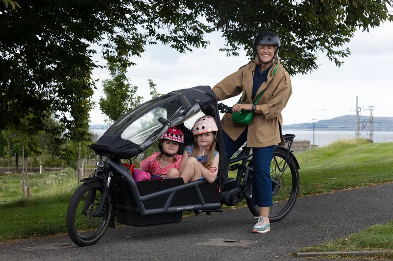 Sterrin O’Shea with her children Esme (5) and Imogen (7) in the cargo bike they use to go to school, at Blackrock, Dublin. Photograph: Alan Betson