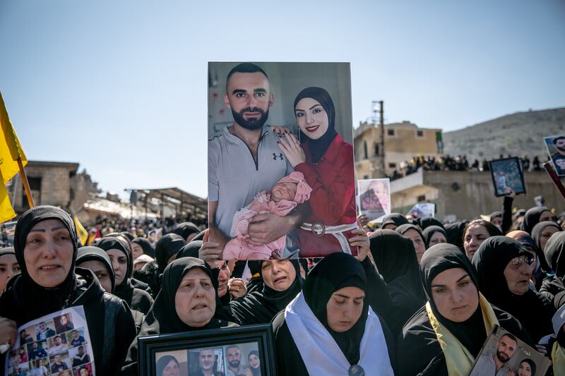 Women mourn at a funeral for 95 people in Aitaroun, close to the Israeli border. Photograph: Sally Hayden