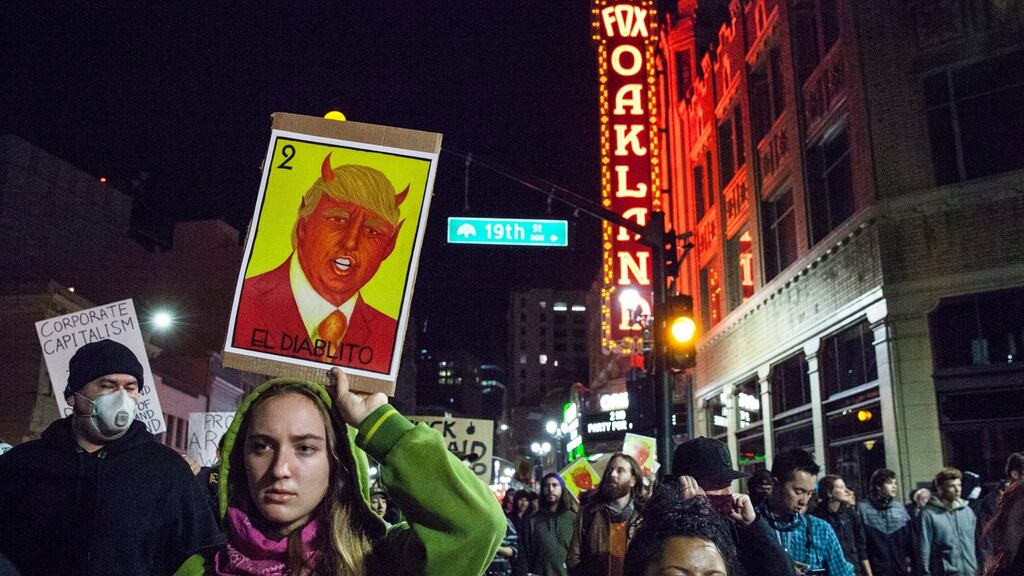 Demonstrators march pass Fox Oakland Theater in protest against President-elect Donald Trump in Oakland, California on Thursday. Photograph: Peter Dasilva/EPA