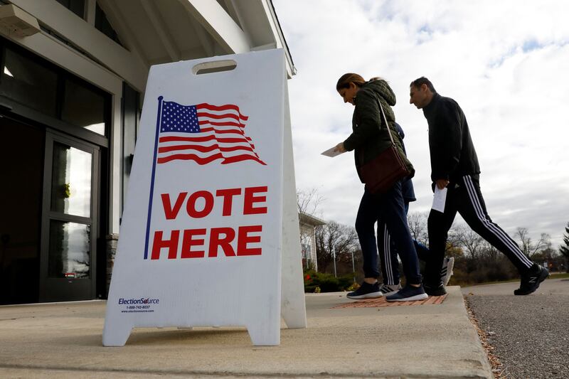 Voters arrive to cast their ballot in Commerce, Michigan. Photograph: Jeff Kowalsky/AFP via Getty Images