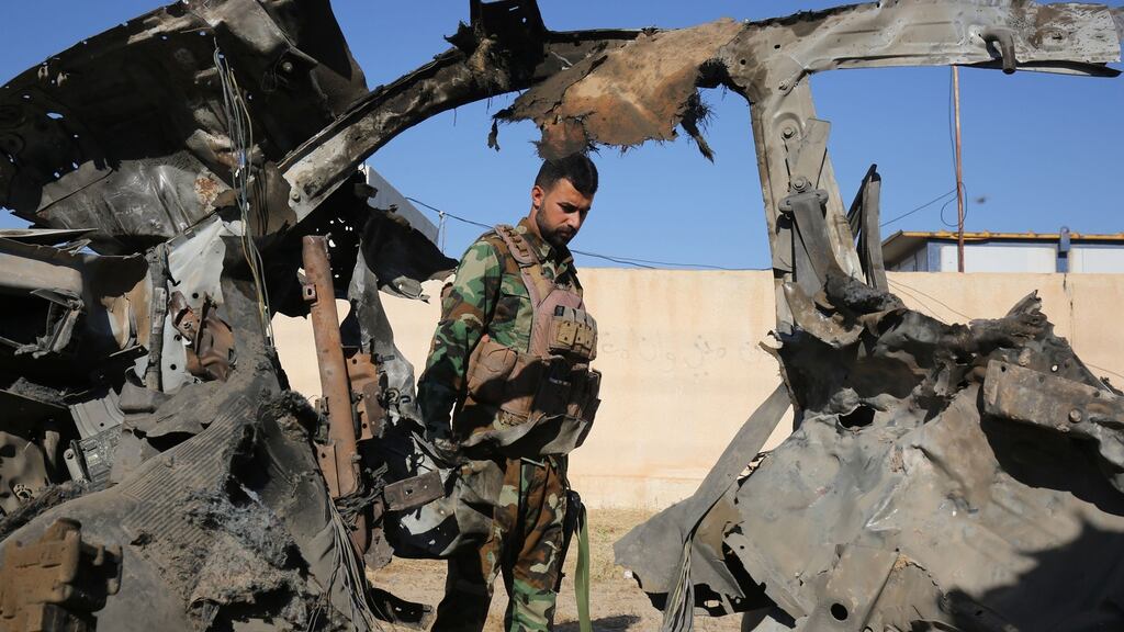 An Iraqi fighter with Hashed al-Shaabi (Popular Mobilisation Forces) inspects the site of an Islamic State attack on the paramilitary force 180km north of Baghdad. Photograph: Getty Images