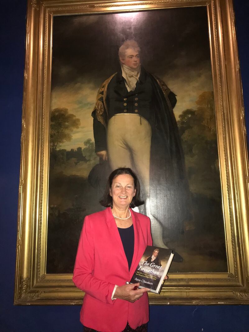 Anne Chambers with her biography of Lord Sligo in front of his portrait in Westport House
