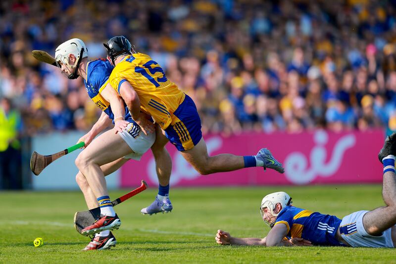 Bryan O’Mara of Tipperary is tackled by David Reidy of Clare. Photograph: Natasha Barton/Inpho