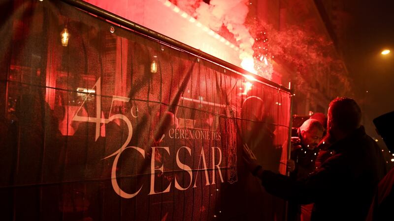 Protesters set off flares during a rally against controversial film director Roman Polanski who is nominated for the Cesar awards. Photograph: AFP/Getty