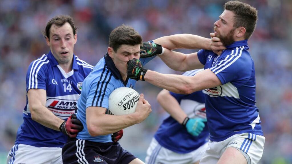 Laois duo Conor Meredith and Paul Begley tackle Dublin’s  Diarmuid Connolly during the Leinster championship clash at Croke Park. Photo: Morgan Treacy/Inpho