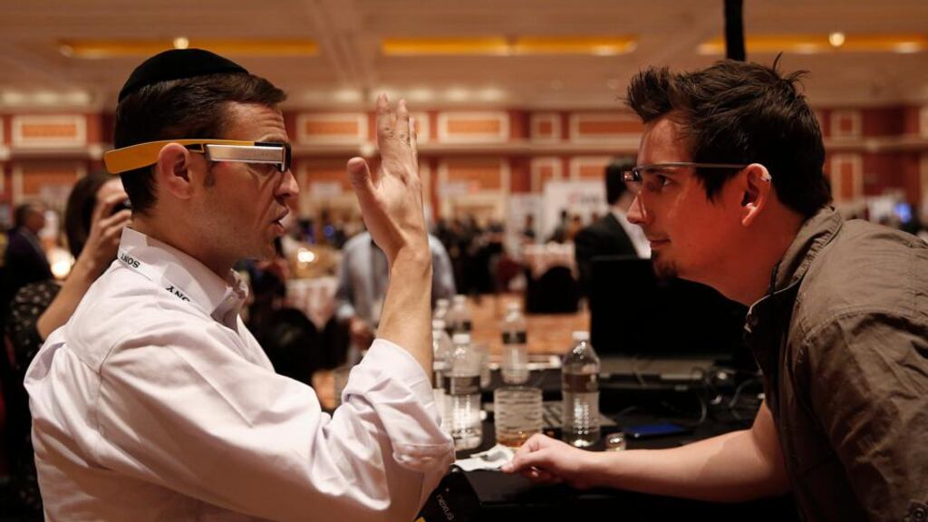 Lumus  exhibitor Ari Grobman, left, wears a pair of DK40 smartglasses while talking with attendee Darren Kitchen wearing Google Glass during the ShowStoppers exhibition at the 2014 Consumer Electronics Show  in Las Vegas. Photograph: Patrick T Fallon/Bloomberg