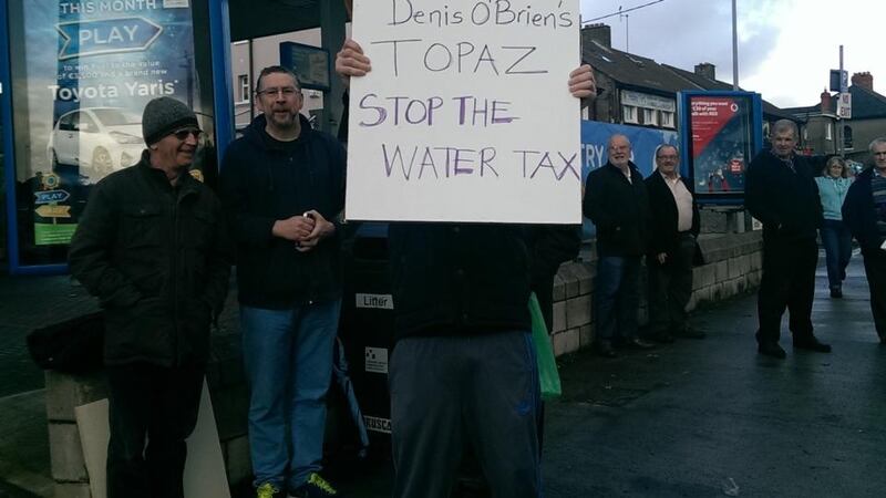Anti-water charge protesters hold a demonstration outside a Topaz outlet in Malahide, Dublin today.