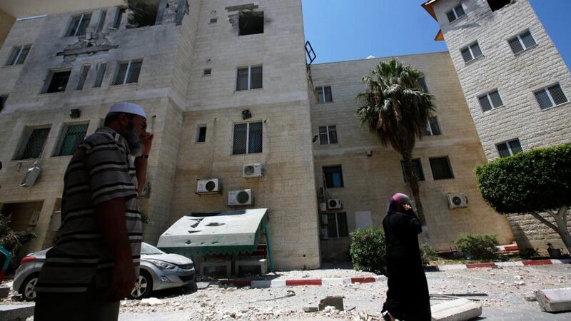 Palestinians inspect a damaged building of Al Aqsa Martyrs hospital after Israeli air strikes in Deir Al Balah town in central Gaza. Photograph: Mohammed Saber/EPA
