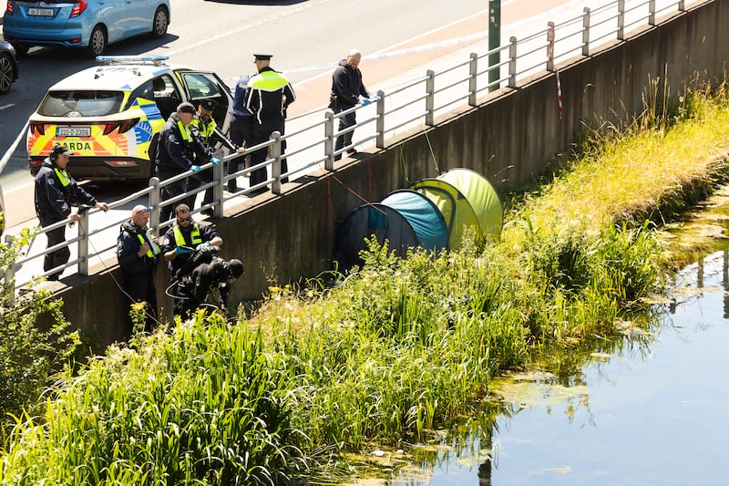 Gardaí inspect the area where the two men slept in their tents, close to where their bodies were found. Photograph: Sam Boal Collins Photos
