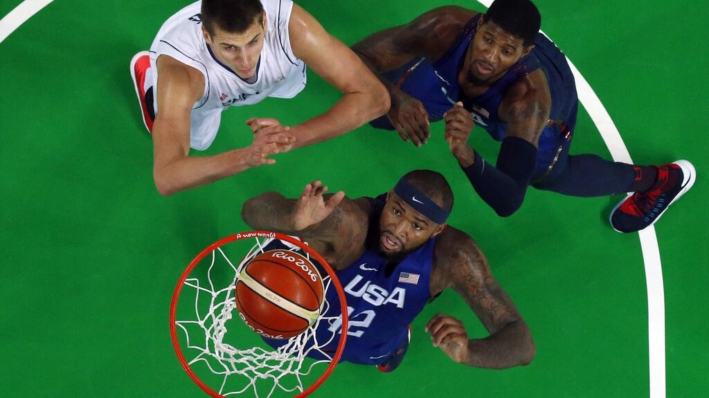 USA’s DeMarcus Cousins (12) and Paul George with Nikola Jokic of Serbia during the men’s basketball final at the Rio Olympics on Sunday. Photograph: Getty Images.
