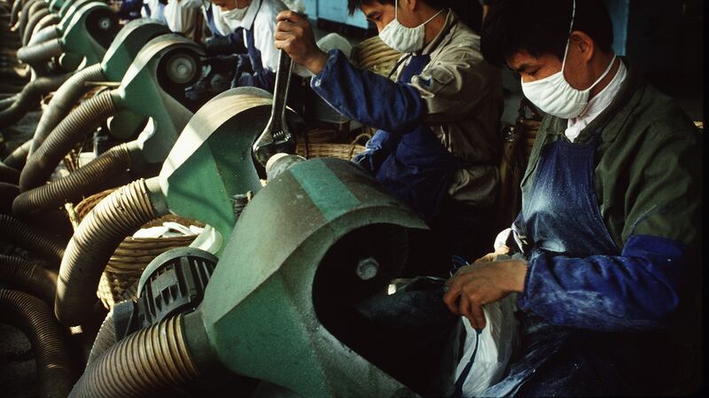 Workers make sneakers at a Nike factory. Photograph: Andrew Holbrooke/Corbis via Getty Images