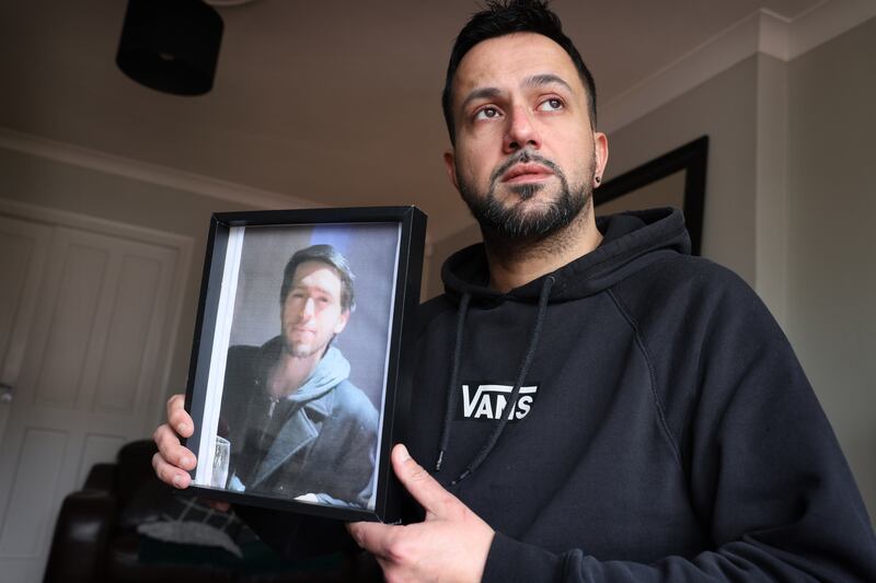 Adam Loughnane's brother Joe Loughnane, holding a photograph of Adam. Photograph: Dara Mac Dónaill