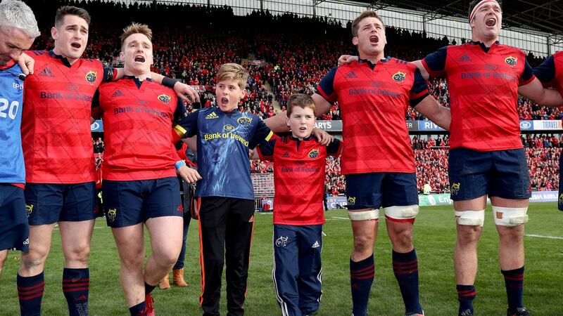 Tony and Dan Foley, sons of the late Anthony Foley sing with the Munster players after the game. Photo: Dan Sheridan/Inpho