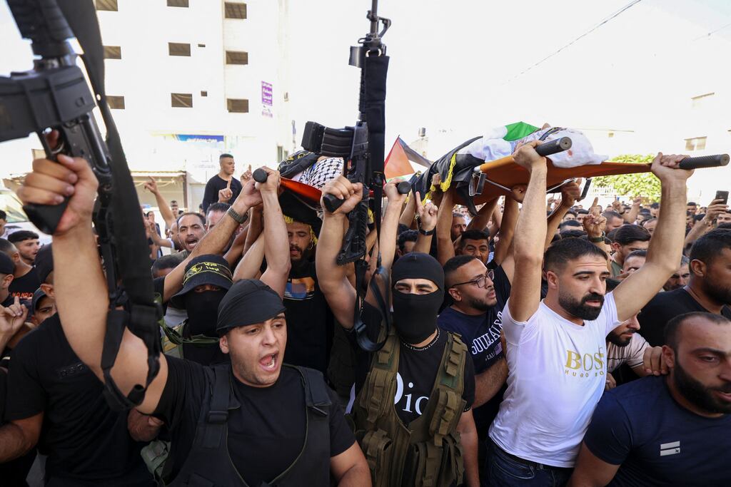 Mourners and militants attend the funeral of alleged Palestinian militants killed by Israel in the Jenin refugee camp, near the West Bank city of the same name. Photograph: Abbas Momani/AFP