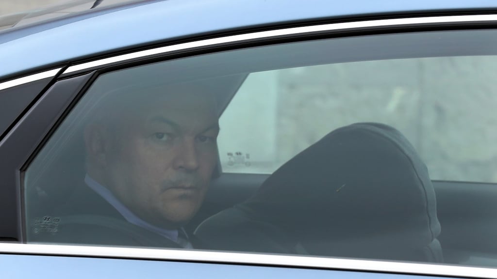 The 16-year-old youth who is charged with the murder of Azzam Raguragui is brought from the Children’s Court last week in a Garda car. Photograph: Collins Courts