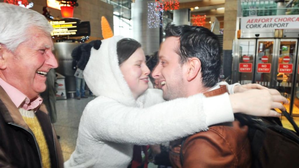 Seán and Noiride Ó Muimhneacháin from Cill na Martra greet son and brother Eoin as he arrives at Cork Airport back from Singapore for Christmas yesterday. Photograph: Daragh Mc Sweeney/Provision