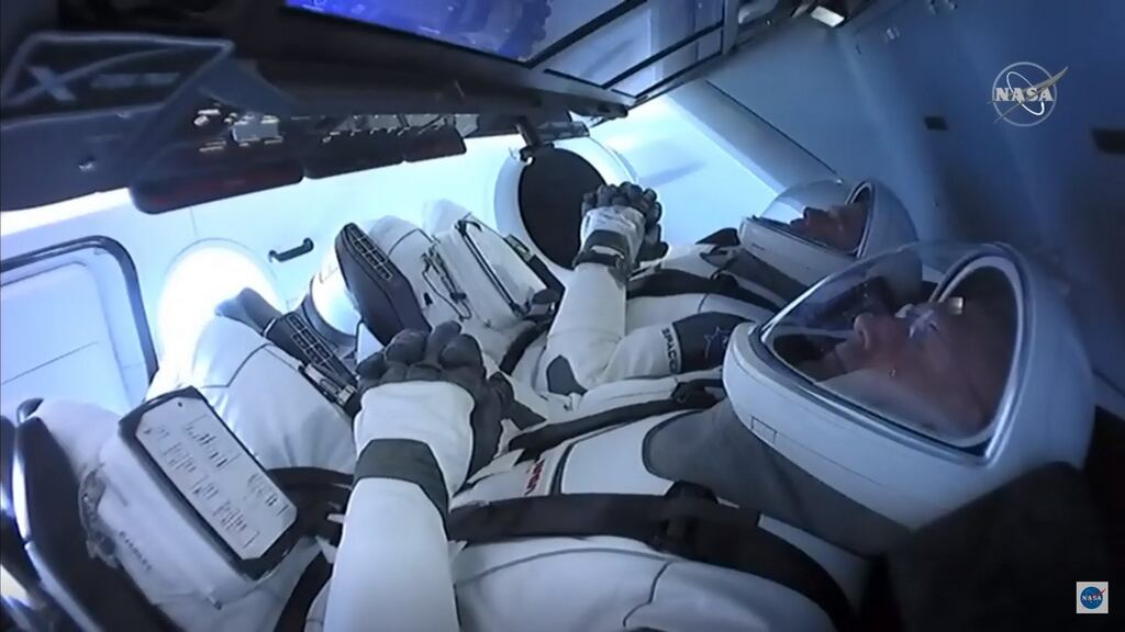 NASA astronauts Bob Behnken  and Doug Hurley (front) in the SpaceX Crew Dragon capsule. Photograph: Nasa TV/AFP via Getty