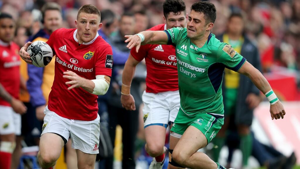 Munster’s Andrew Conway goes past Tiernan O’Halloran of Connacht during their Pro12 clash. Photo: Bryan Keane/Inpho