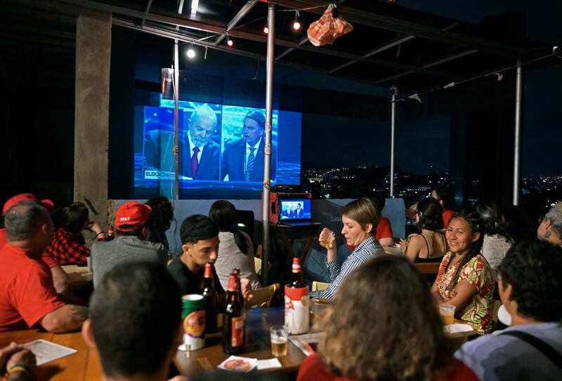 Rival candidates Luiz Inácio Lula da Silva and Jair Bolsonaro are seen on the screen as Brazil's televised presidential election debate is projected on to a building in Rio de Janeiro on Sunday. Photograph: Carl de Souza/AFP via Getty Images