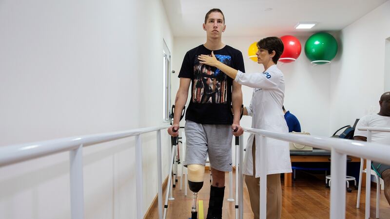 Jakson Follman  during physiotherapy in Sao Paulo, Brazil. Photograph: Lalo de Almeida/The New York Times