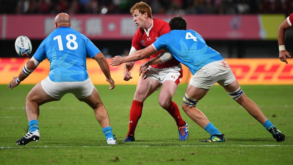 Wales’ outhalf Rhys Patchell is tackled by Uruguay’s Juan Pedro Rombys and Ignacio Dotti during the 2019 Rugby World Cup Pool D match between Wales and Uruguay at the Kumamoto Stadium. Photo: Gabriel Bouys/EPA