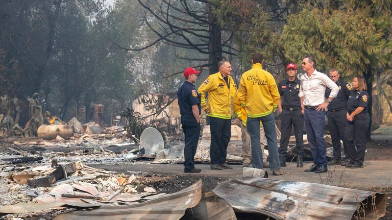 California Govenor  Gavin Newsom (white shirt)  tours a home destroyed by the Kincade fire on Friday. Photograph: AP