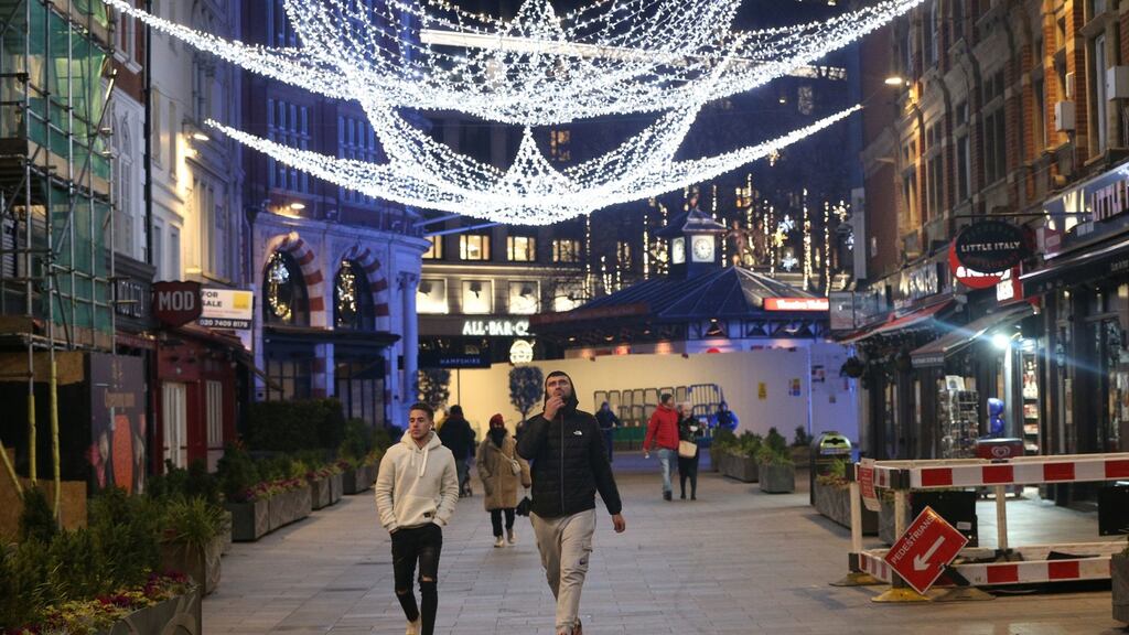 People look at the lights in Irving Street off Leicester Square in a quiet central London as Cvoid-19 case rates rise in all regions of England. Photograph: Jonathan Brady/ PA Wire