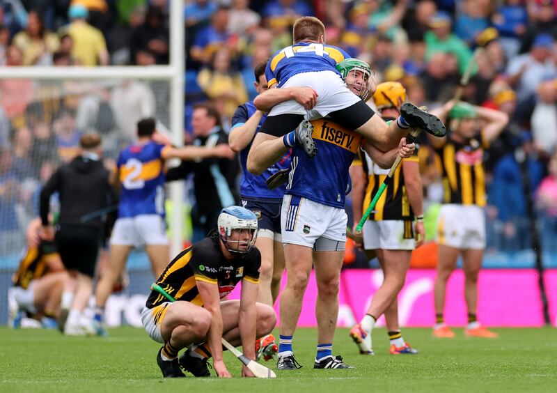 Tipperary’s Noel McGrath celebrates with his brother John as Kilkenny’s Huw Lawlor looks on dejected after the All-Ireland semi-final. Photograph: James Crombie/Inpho