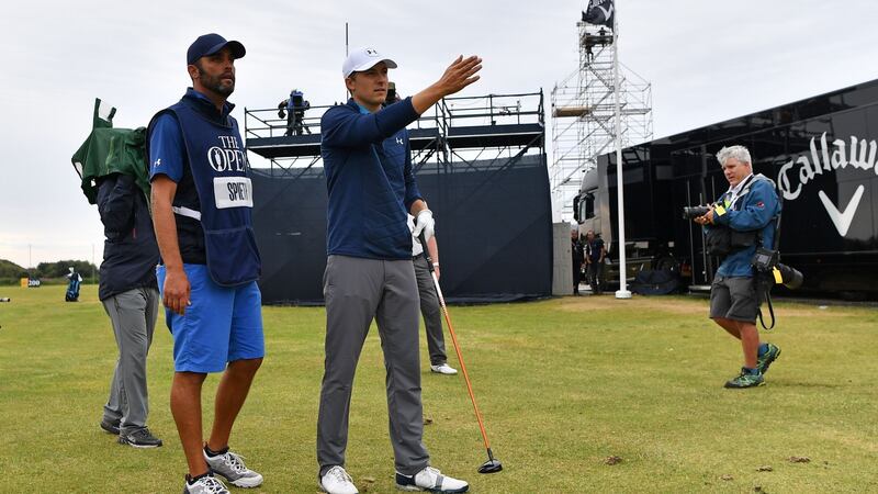 Jordan Spieth  considers his options with caddie Michael Greller  on where to place the ball after taking a penalty drop for having an unplayable lie on the crucial 13th hole.  Ben Stansall/AFP/Getty Images