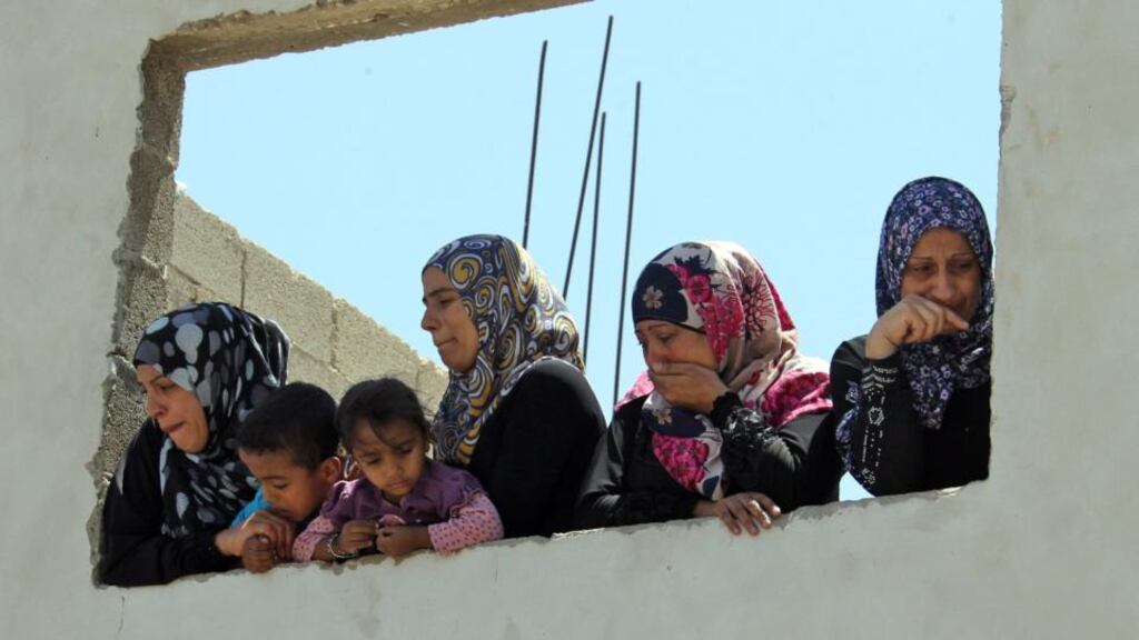 Relatives of Palestinian youth Yousef Abu Zagha watch the teenager’s funeral at the Jenin refugee camp, West Bank yesterday. Photograph: Alaa Badarneh/EPA