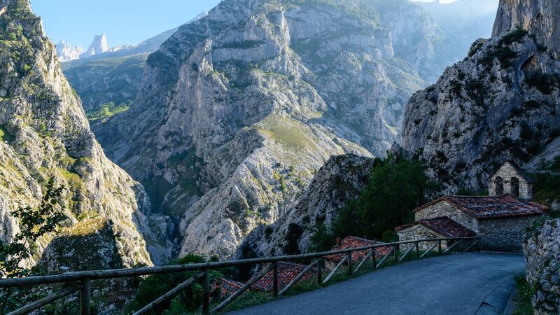 A village in Asturias, with the Picos De Europa in the background