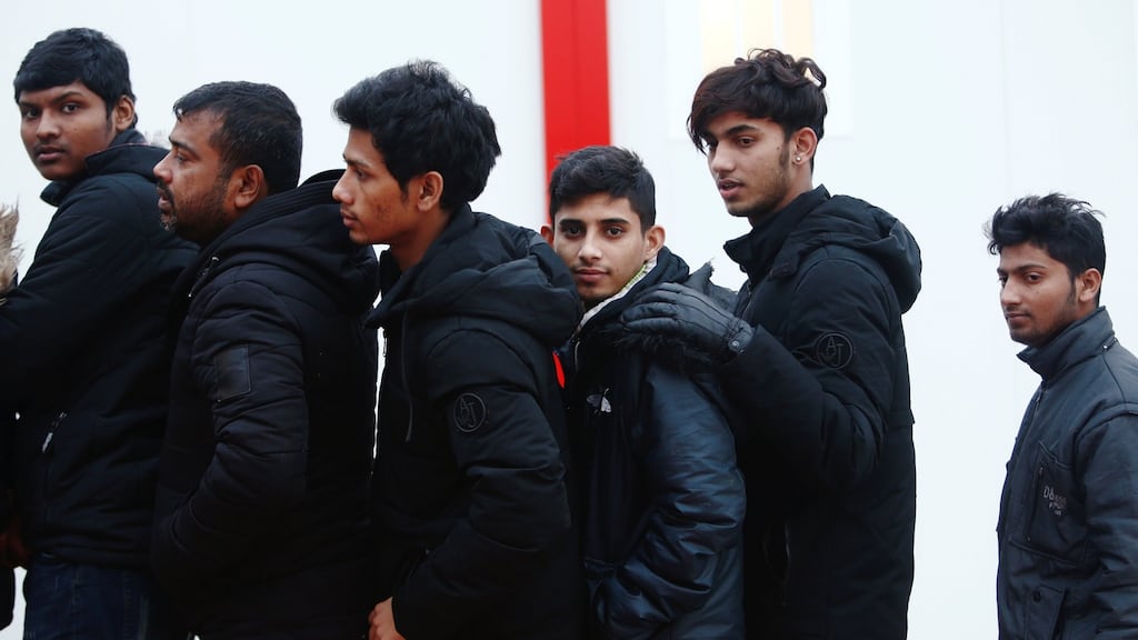 Migrants intercepted off the coast in the Mediterranean Sea line up after arriving on a rescue boat at the port of Malaga in Spain. Photograph: Jon Nazca/Reuters